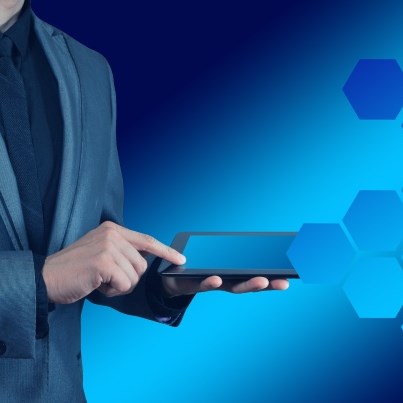 stylized image of person in a business suit touching a tablet